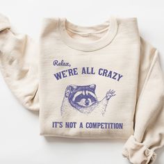 Relax We're All Crazy It's Not A Competition Sweatshirt, Funny Sweatshirt, Vintage Retro Graphic Shirt, Mental Health Shirt, Raccoon Shirt 🧵 HOW TO ORDER   - Pick your size and color from the drop down menus  - Review the sizing and color options in the listing photos  - Add the item to your cart and complete the checkout process  - We'll start working on your order right away! 🧵SIZING  - Please review the listing photos to see the size charts  - These photos will also show you how to order a San Jose, Funny Quotes T Shirts, Game Day Apparel, Aba Therapy Shirts, Sweatshirts Mental Health, Funny T-shirt, Funny Shirts Women Hilarious, Cricut Sweatshirt, Adulting Funny