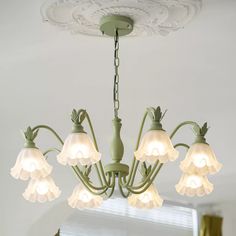 a green chandelier with five lights hanging from it