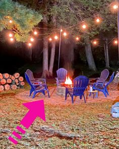 a fire pit surrounded by chairs and lights