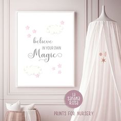 a poster with the words believe in your own magic on it next to a bed