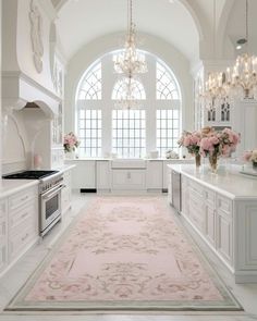 a white kitchen with pink rug and chandelier