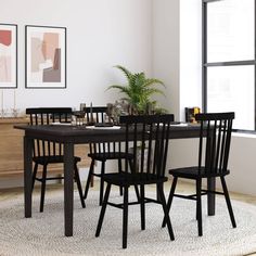 a dining room table with chairs and a potted plant on top of the table