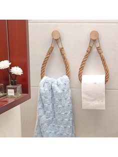 two rope wrapped towels hanging on the wall