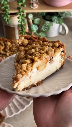 a person holding a piece of pie on a plate