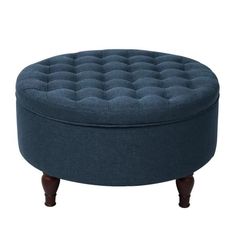 a round ottoman with wooden legs and an upholstered cushion on the top is shown