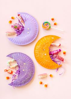 three paper plates with crescents and stars on them sitting next to candy candies