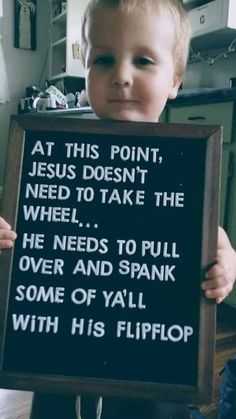 a little boy holding up a sign that says at this point jesus doesn't need to take the wheel he needs to pull over and spark some of y'all with his flip flop