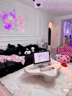 a living room filled with black couches and pink furniture next to a white coffee table