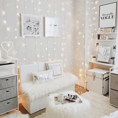 a room with white furniture and lights on the walls