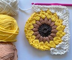 two balls of yarn are sitting next to each other on a table with crochet