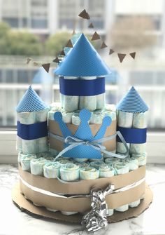 a cake made to look like a castle with blue and white icing on it