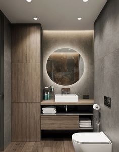 a bathroom with a toilet, sink and mirror in the wall next to wood flooring