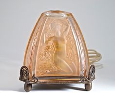 an antique glass object with a woman's face on it