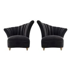 two black velvet chairs with wooden legs