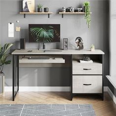 a desk with a computer on top of it in front of a wall mounted plant