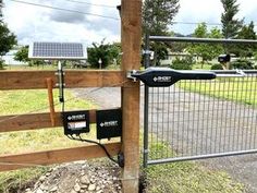 an electric fence with two solar panels attached to it and some wires connected to the posts