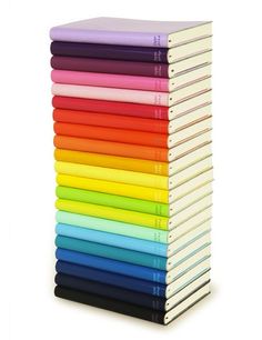 a stack of colored notebooks sitting on top of each other