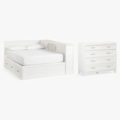 a white bed sitting next to a dresser and night stand with drawers on each side