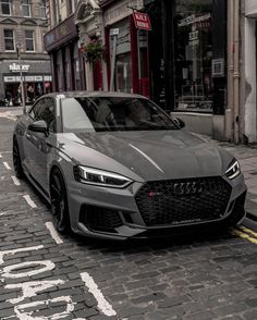 a grey car parked on the side of a street