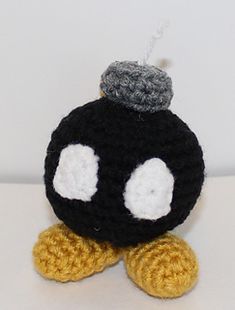 a crocheted black and white stuffed animal