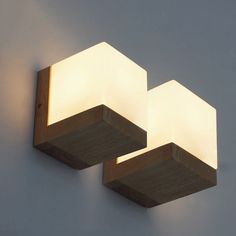 two light fixtures mounted to the side of a wall