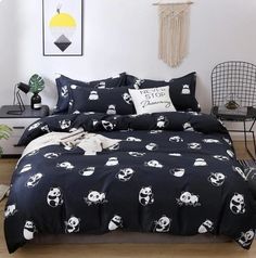 a black and white bed with pandas on it