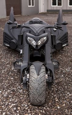 an image of a motorcycle that is in the middle of some gravel and has been modified to look like a batmobile