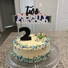 a birthday cake with the number two on it sitting on top of a countertop