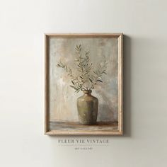 a painting hanging on the wall above a vase filled with flowers in it's corner