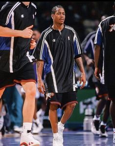 the basketball players are walking on the court