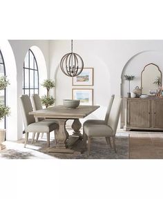 a dining room table and chairs in front of arched windows