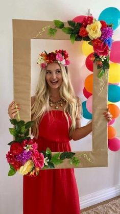 a woman in a red dress holding up a photo frame with flowers on it and the words click here to view more