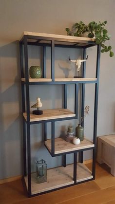 a shelf with vases and other items on it in the corner of a room