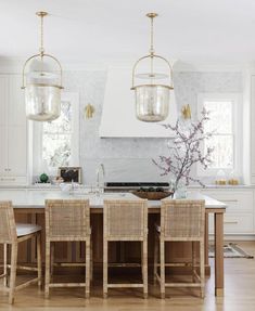 So many details to appreciate from the light fixtures to tile backsplash everything in this kitchen came together beautifully. Design by Dominique DeLaney, photo by Laura Sumrak Transitional Kitchen Ideas, Light Gray Cabinets, Beautiful Backsplash, Transitional Kitchen Design, Off White Kitchens, White Marble Kitchen, Rattan Stool, White Backsplash, Chrome Bathroom