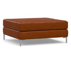 a brown ottoman sitting on top of a metal frame