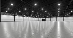 an empty warehouse with lights on the ceiling