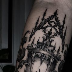 a man's arm with a clock and crown tattoo on it