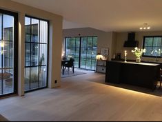 a large open living room and kitchen area with sliding glass doors that lead to an outside deck