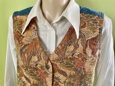 You will be looking as fresh as a daisy in this sweet vintage women's vest. A lovely tapestry brocade fabric with cowboys on horses herding cows on the front with a slight peaked edge, and blue denim on the back. A v-neckline and metal button closures. The back has a size-adjusting tie and buckle.  In Excellent, almost new condition.  Size Medium Measurements: Chest: 98 cm / 38 inches Length: 58 cm / 23 inches Shoulder: 37 cm / 14 inches This item is one of a kind. BUYING VINTAGE: While all care is taken to state any obvious faults, please note that when you buy a vintage or preloved item, they may show small signs of ageing, wear and/or repair. Visit my new website   https://phoenixmenswear.com.au/ Lots of fun stuff for guys and girls...!! Please note that if you are ordering from anywher Cowboys On Horses, Tapestry Vest, Fresh As A Daisy, Aran Cardigan, Women's Vest, Vintage Vans, Brocade Fabric, Vest Outfits, 1980s Vintage