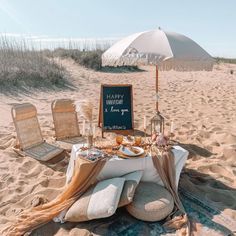 a table set up on the beach with an umbrella