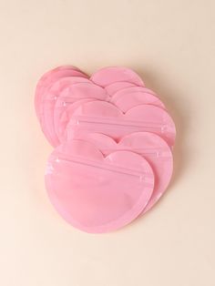 six pink heart shaped plates sitting on top of each other