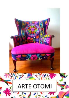 a colorful chair sitting on top of a wooden floor next to a sign that says art otomi