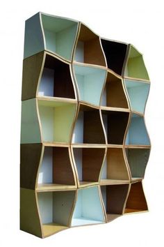 a book shelf with many different colored shelves