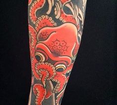 an octopus tattoo on the arm and leg is shown in red, black and grey