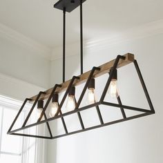 a light fixture with five lights hanging from it's center and four bulbs on each end