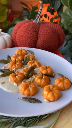 small pumpkins on a plate with cream sauce and green beans in the middle, surrounded by leaves