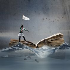 a woman holding a flag standing on top of an open book