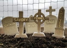 three headstones are placed next to each other on the ground in front of a net