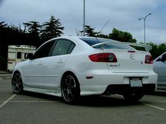 a white car parked in a parking lot