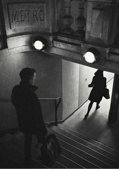 a woman walking up the stairs in a building